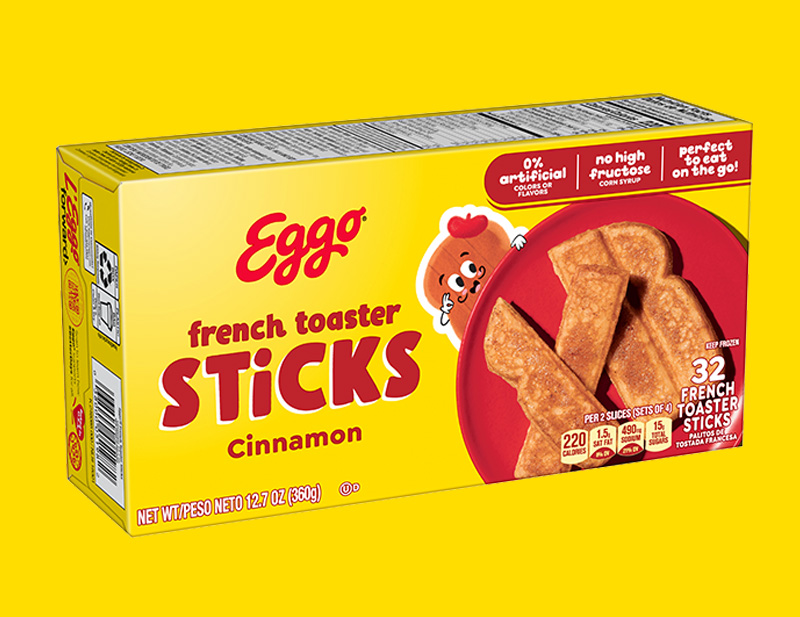 A french toast stick being dipped in syrup