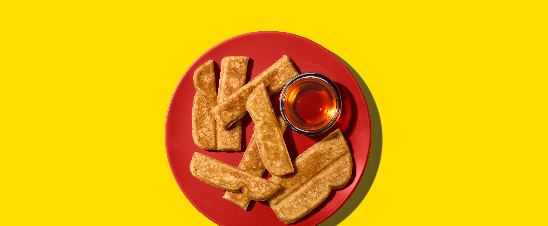 Eggo French Toaster Sticks popping out of a toaster.
